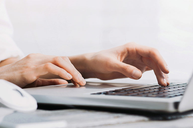 hands on laptop keyboard